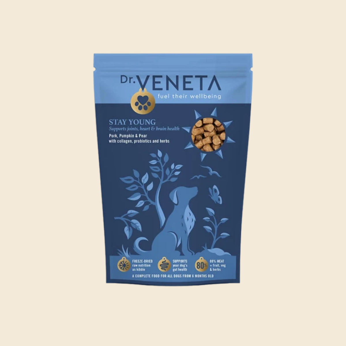A stand-up pouch of Dr. Veneta Stay Young dog food, featuring a blue and navy design with a dog silhouette and a circular image of the kibble, set against a solid beige background.